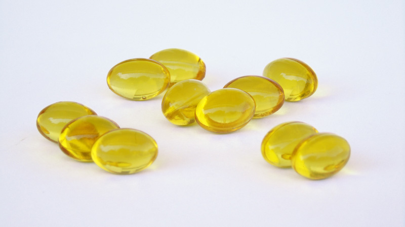 CBD softgels lying on white background