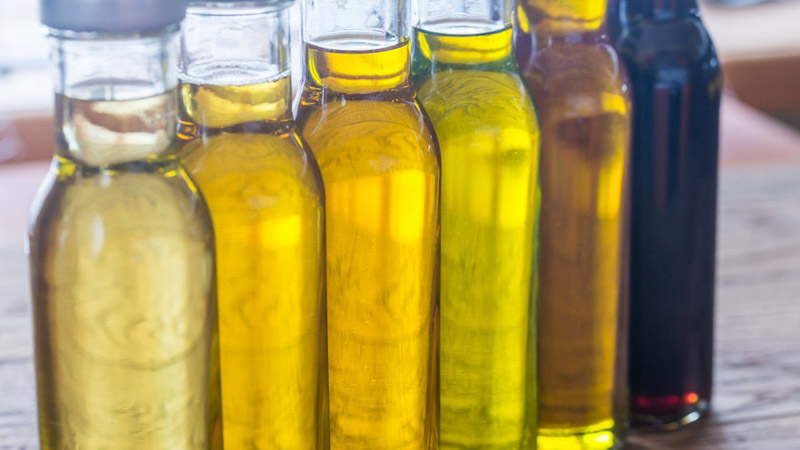 Different types of vegetable oils inside glass bottles