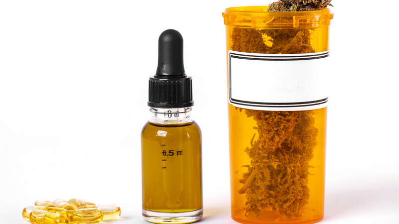 CBD oil extracted from marijuana in glass bottle and capsules
