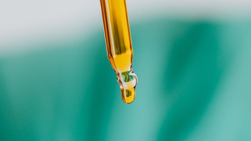 CBD oil dropping from a dropper 
