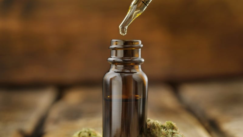 A CBD oil bottle and dropper without any labels