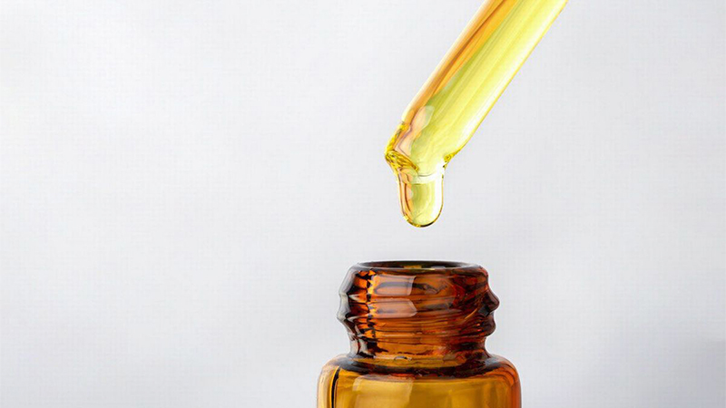 CBD Oil with a dropper in white background.