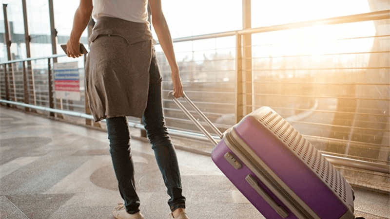 Woman_carrying_luggage_with_CBD